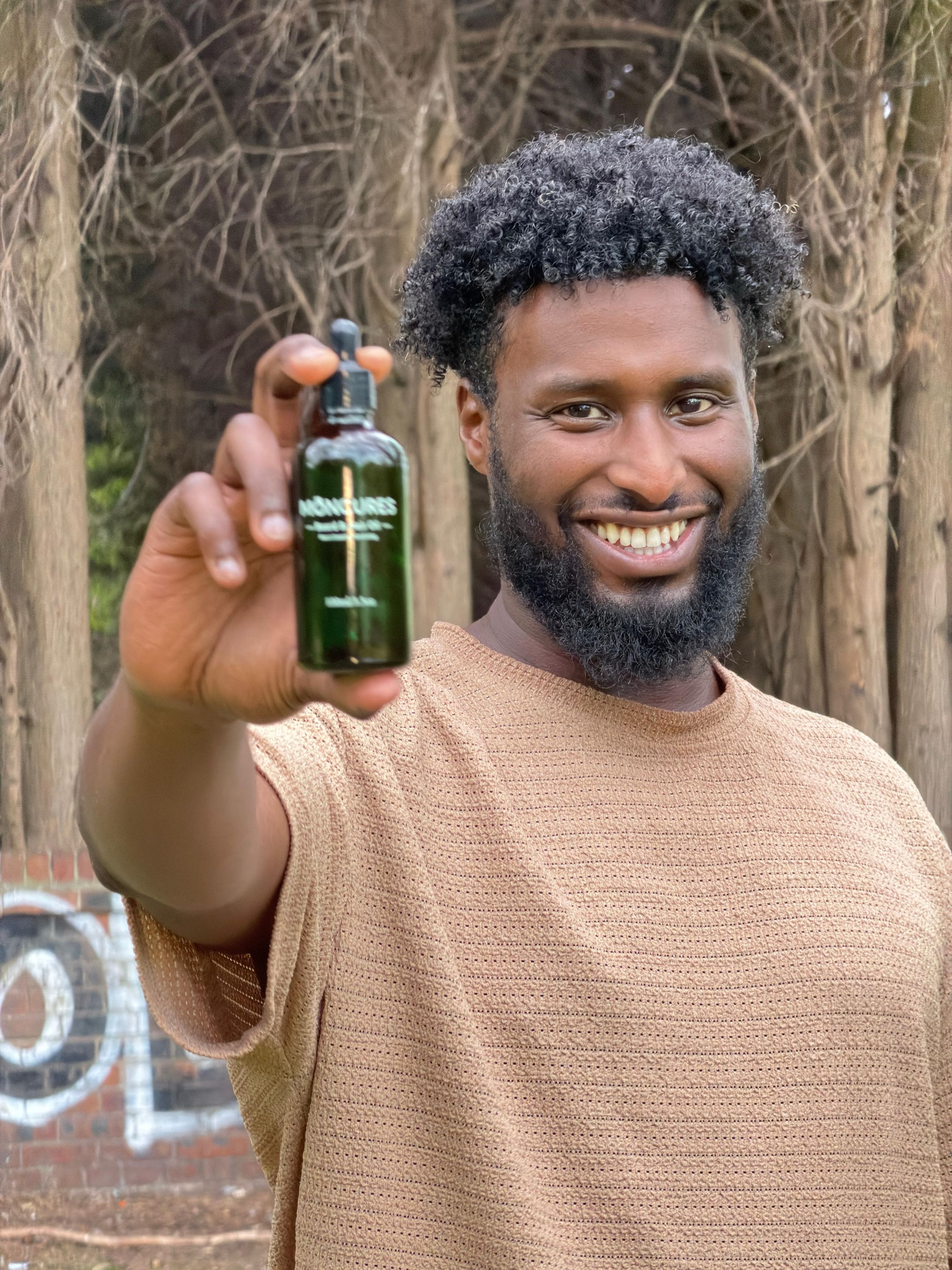 Moncures beard and hair oil held by a founder